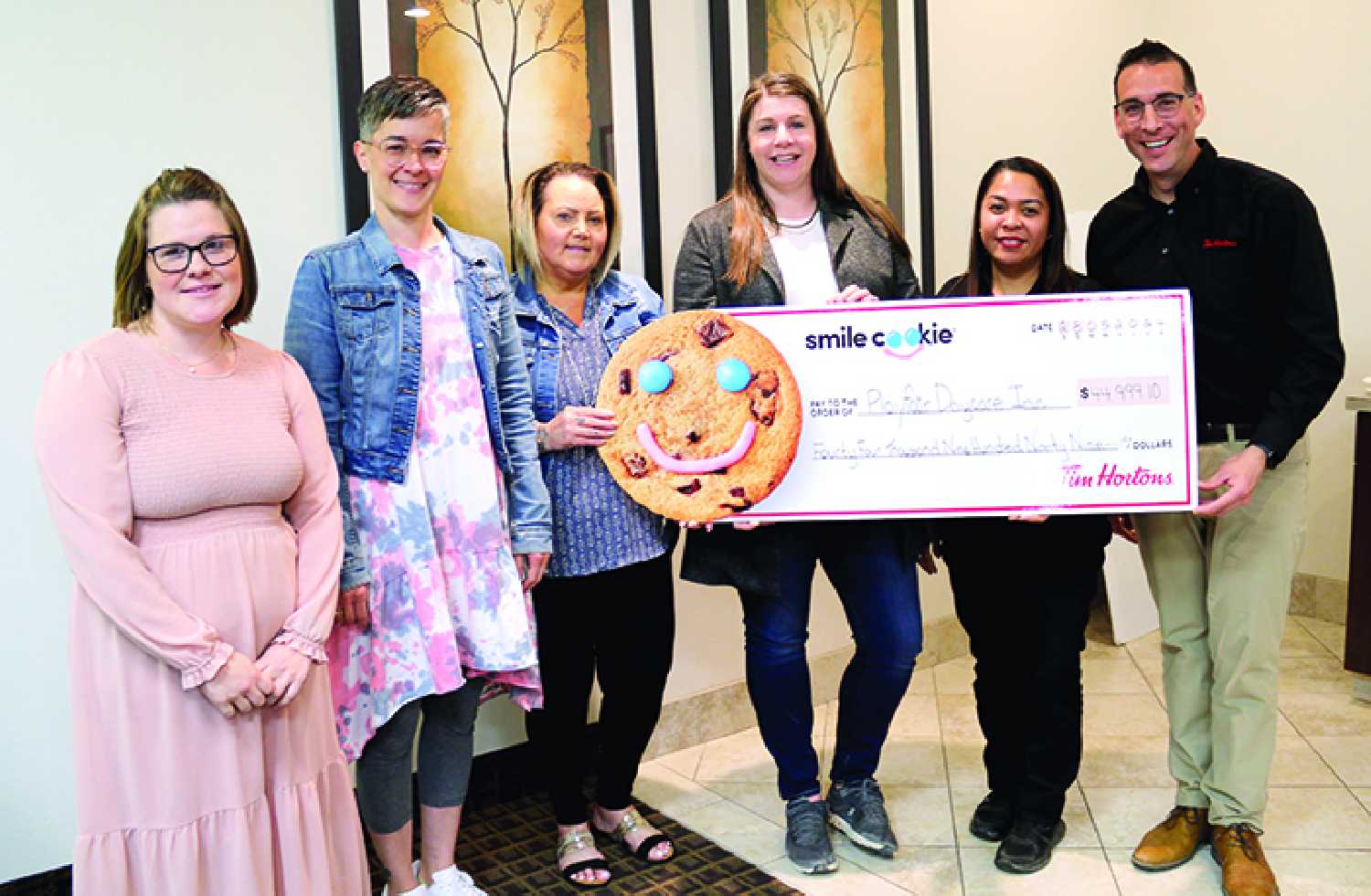 Tim Hortons presented $45,000 to Play Fair Daycare at the Moosomin Chamber of Commerce meeting Wednesday with money raised from its spring Smile Cookie fundraiser. From left are Samantha Campbell, Ami Leduc, Terri Lowe, and Jill Jones with the daycare committee, and Cherrie Caliwag and Greg Crisanti with Tim Hortons Moosomin. Moosomin was first in Saskatchewan and sixth in Canada for Smile Cookie sales.